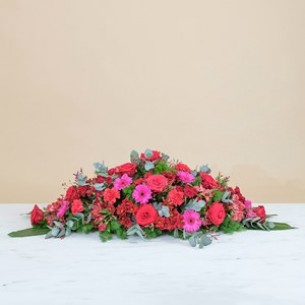 Coffin cover with red ros..